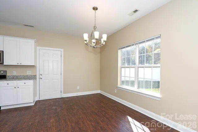 a view of a kitchen with an empty space and a window