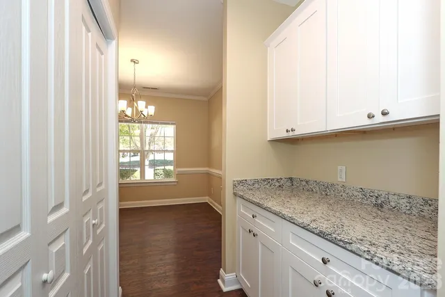 a kitchen with cabinets stainless steel appliances and a sink