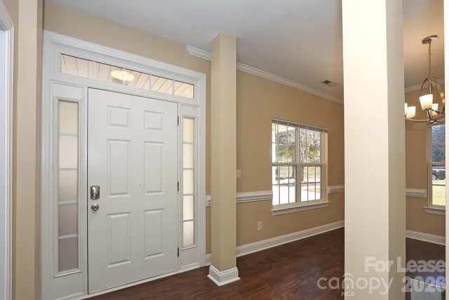 a view of an entryway with wooden floor