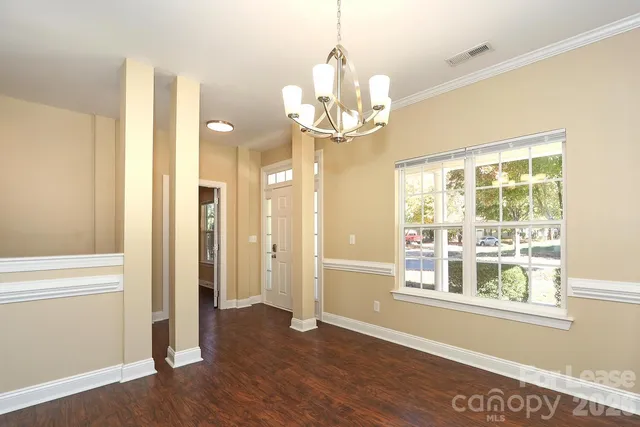 a view of a room with wooden floor and door