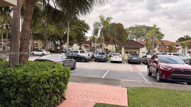9691 Southwest 138th Avenue, Unit QC2L Miami, FL 33186 - Photo 17 of 48 a row of parked cars parked in front of a house