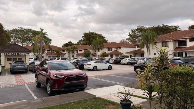 9691 Southwest 138th Avenue, Unit QC2L Miami, FL 33186 - Photo 18 of 48 a car parked in front of a brick house
