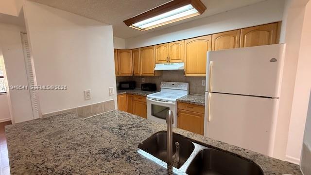 9691 Southwest 138th Avenue, Unit QC2L Miami, FL 33186 - Photo 26 of 48 a kitchen with a refrigerator sink and cabinets