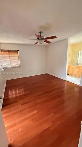 a view of room with ceiling fan and window