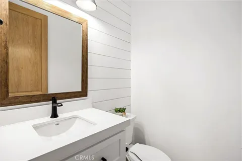 a bathroom with a sink a toilet and mirror