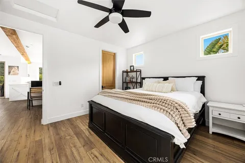 a bedroom with bed and wooden floor