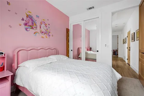 a bedroom with a bed and a mirror