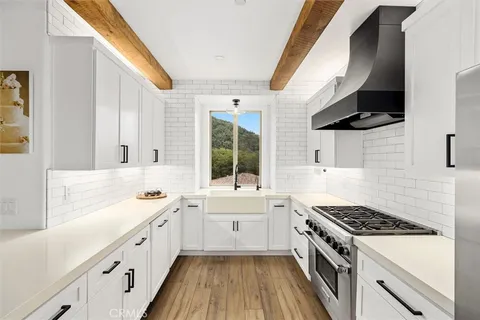a kitchen with a sink stove and cabinets