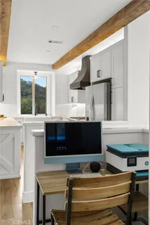 a living room with stainless steel appliances kitchen island granite countertop furniture and a fireplace