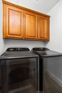 a kitchen with wooden cabinets and a stove top oven
