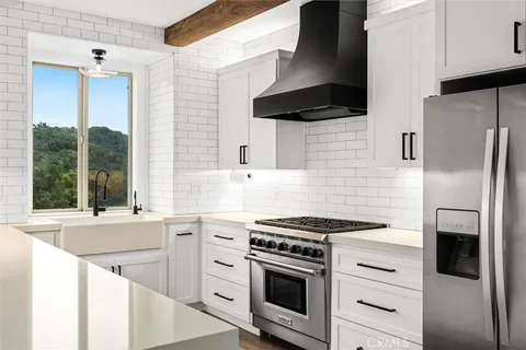 a kitchen with stainless steel appliances white cabinets and a stove