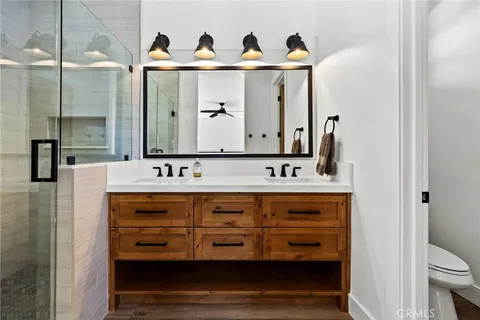a bathroom with a double vanity sink and a mirror