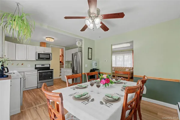 a view of a dining room with furniture window and wooden floor