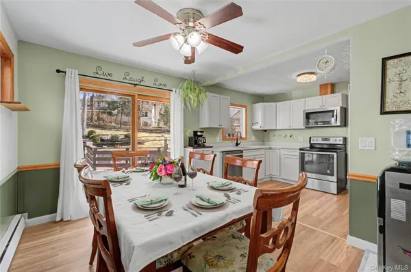a view of a dining room with furniture window and wooden floor