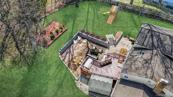 a view of a house with backyard water fountain and sitting area