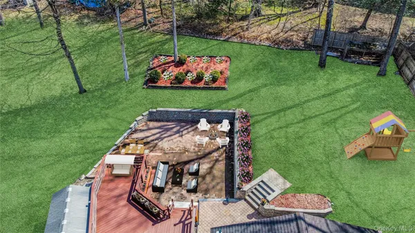 an aerial view of a house with a yard basket ball court and outdoor seating