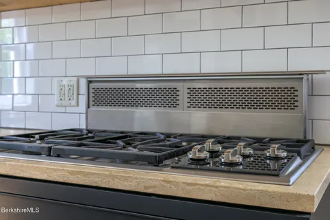 a kitchen with stainless steel appliances granite countertop a stove and a refrigerator