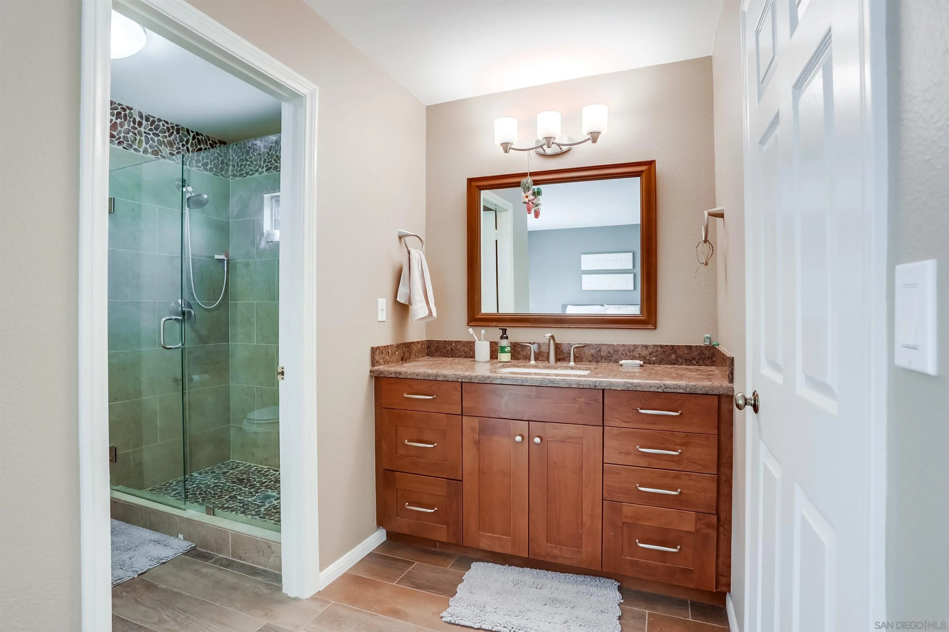 23409 Everett Place Ramona, CA 92065 - Photo 12 of 29 a bathroom with a sink vanity and a mirror