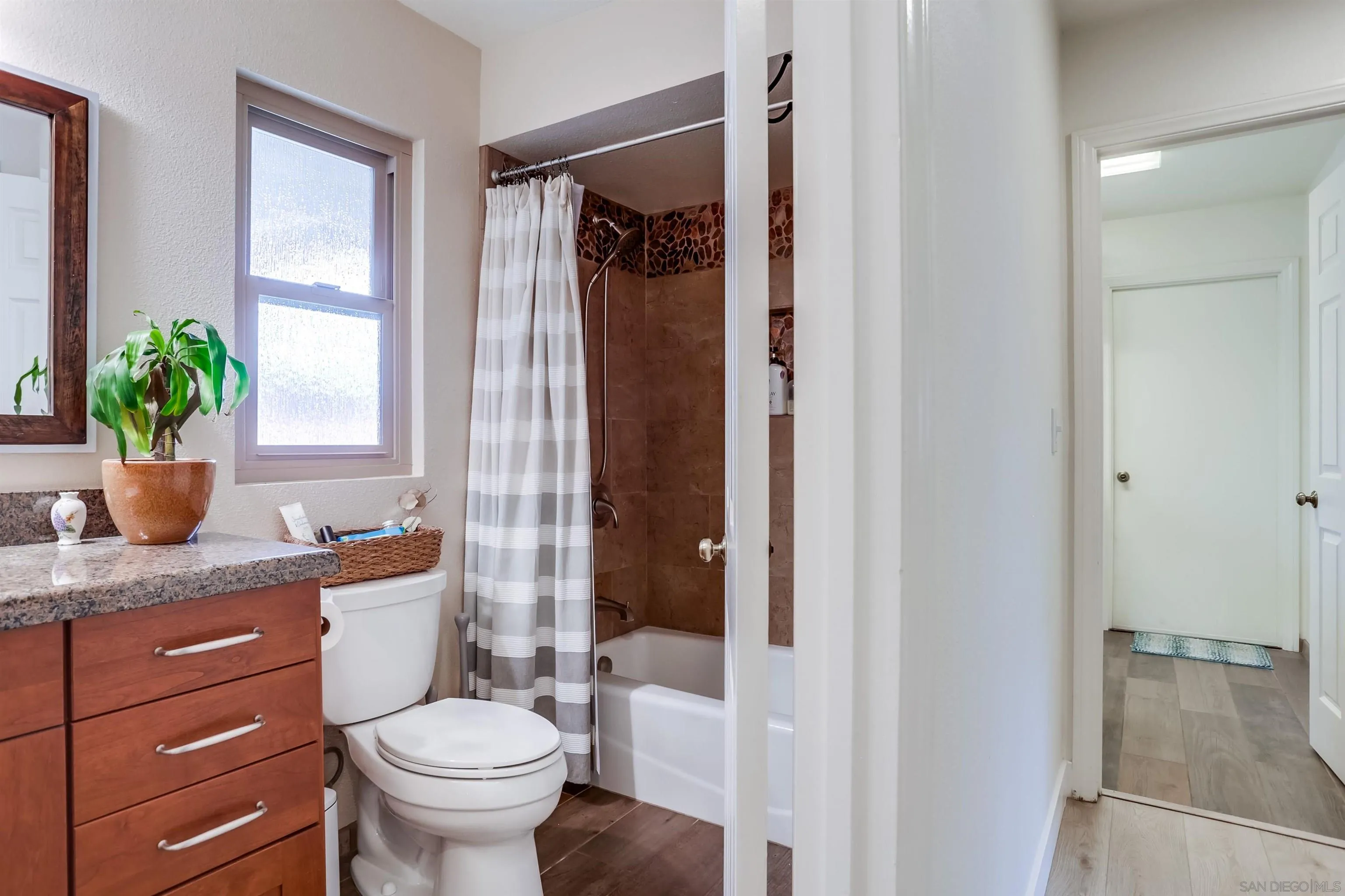 23409 Everett Place Ramona, CA 92065 - Photo 18 of 29 a bathroom with a granite countertop sink toilet and shower