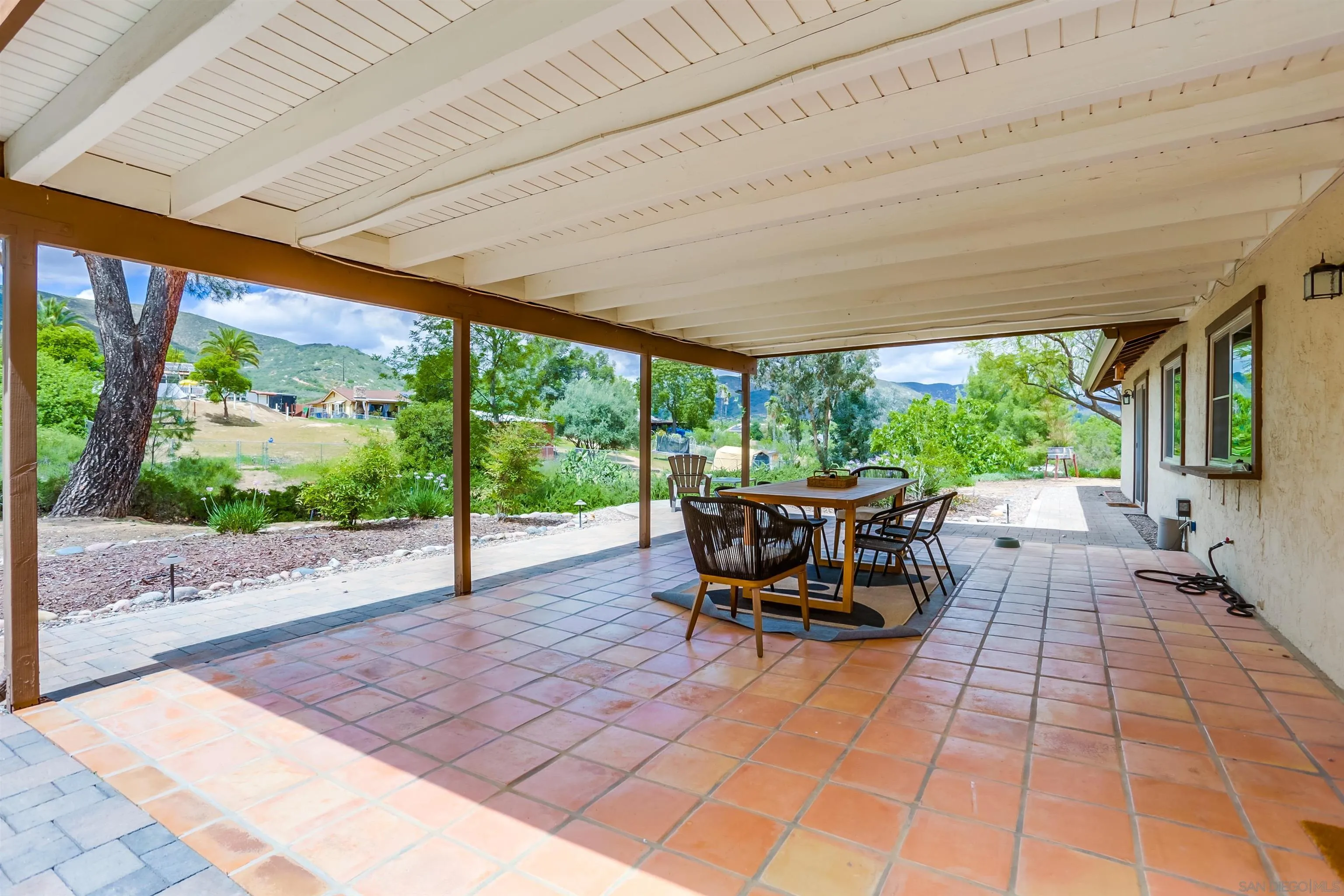 23409 Everett Place Ramona, CA 92065 - Photo 20 of 29 a view of a patio with table and chairs potted plants with wooden floor