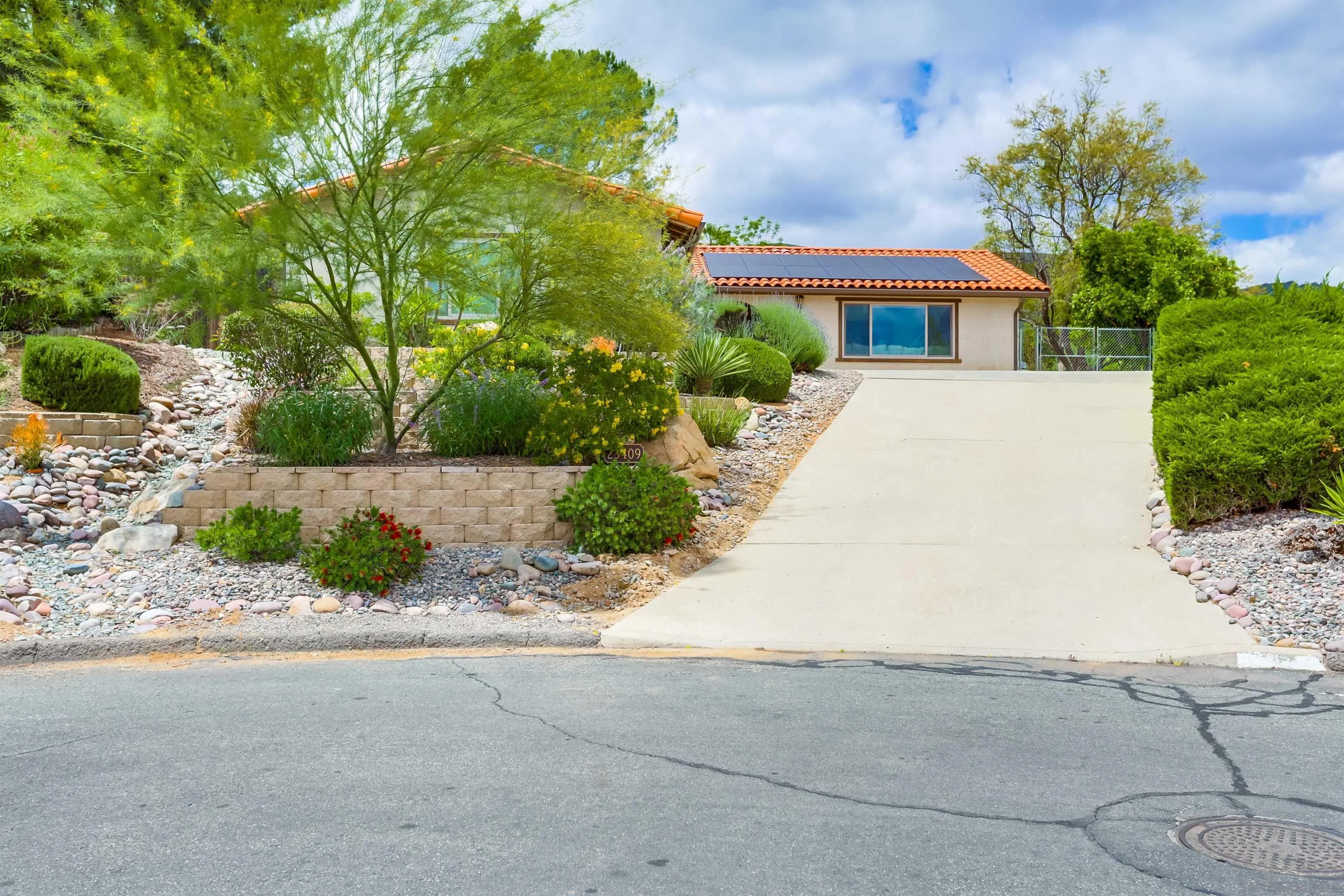 23409 Everett Place Ramona, CA 92065 - Photo 27 of 29 a front view of a house with a yard and potted plants