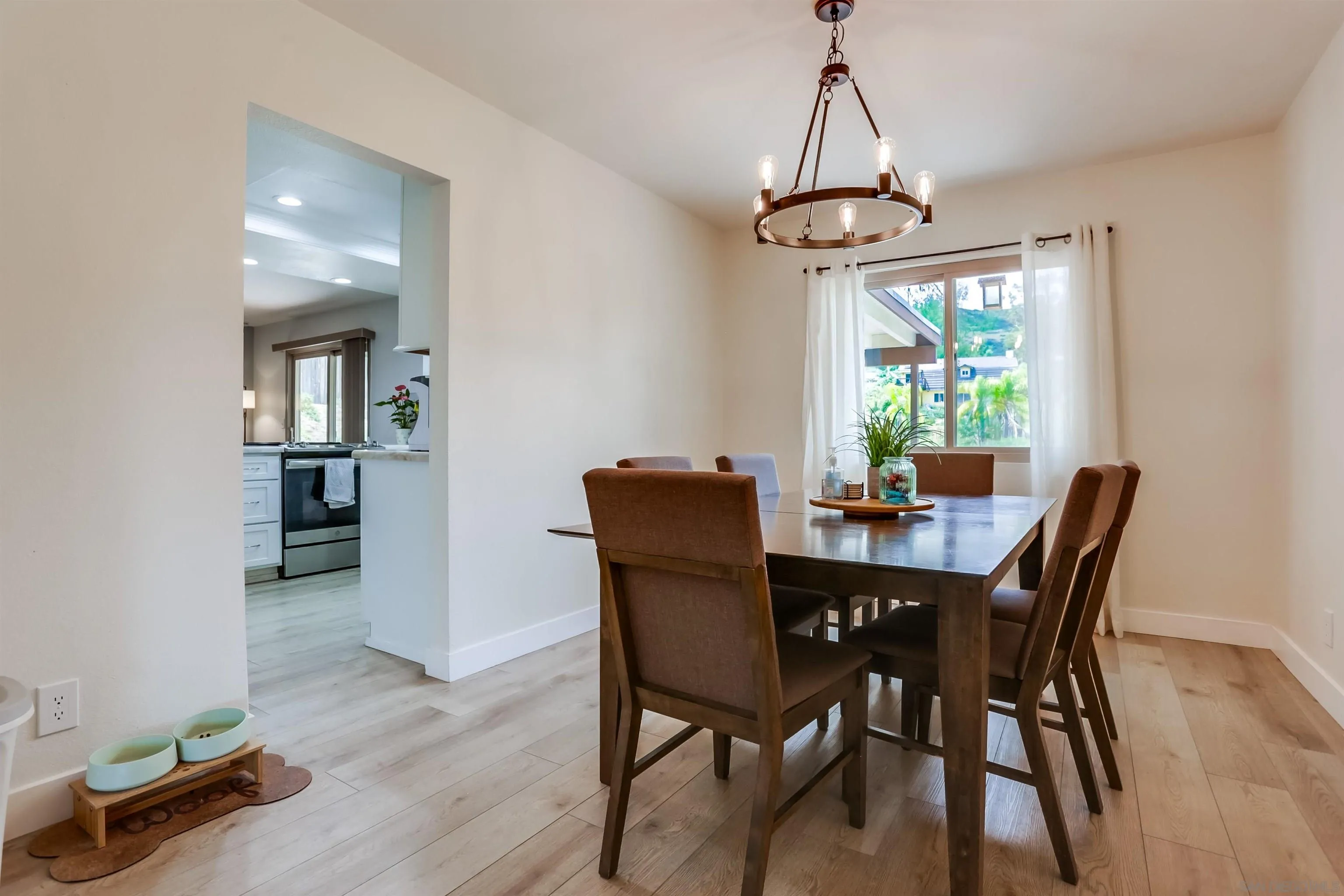 23409 Everett Place Ramona, CA 92065 - Photo 4 of 29 a dining room with furniture window and wooden floor