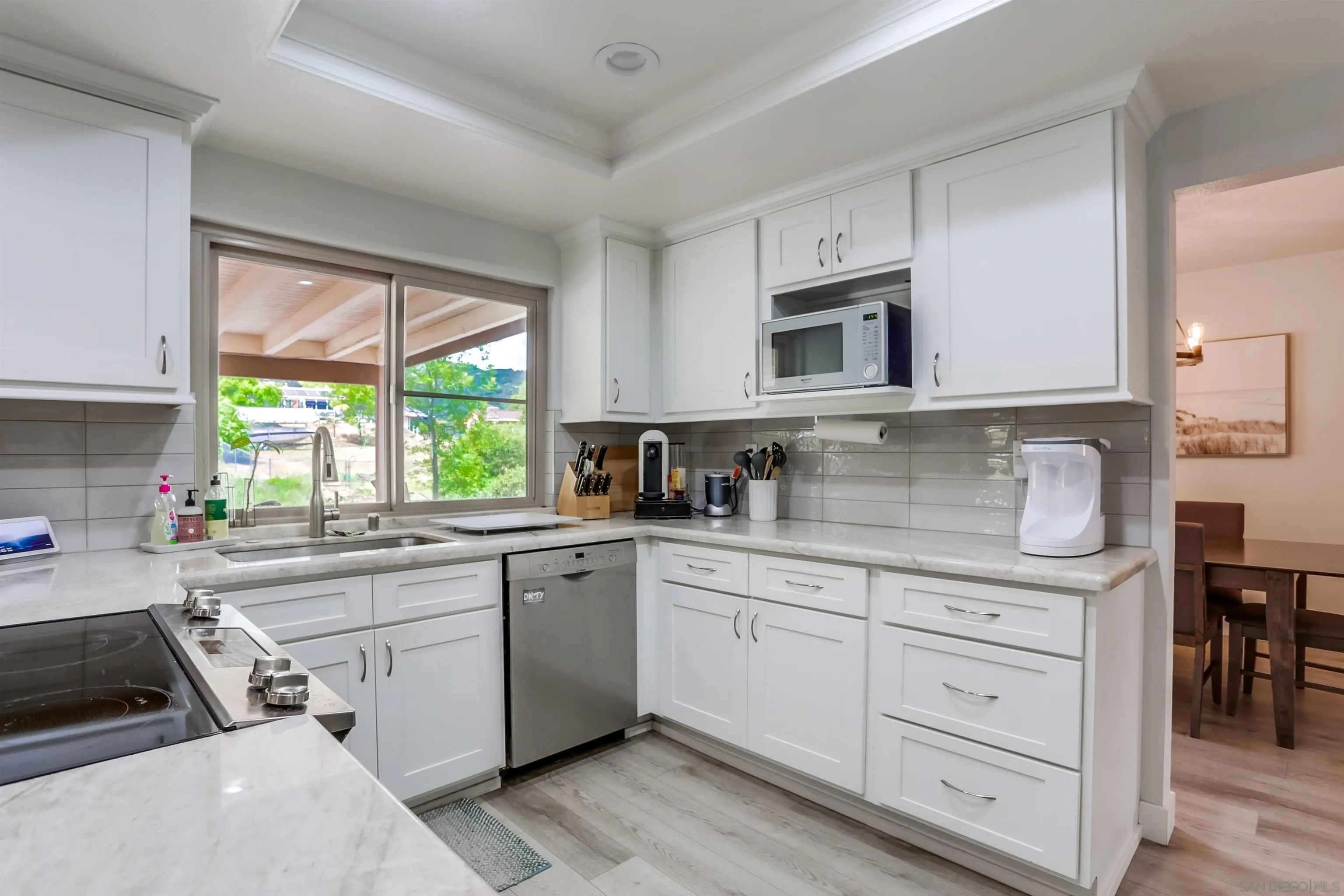 23409 Everett Place Ramona, CA 92065 - Photo 7 of 29 a kitchen with cabinets appliances a sink and a window