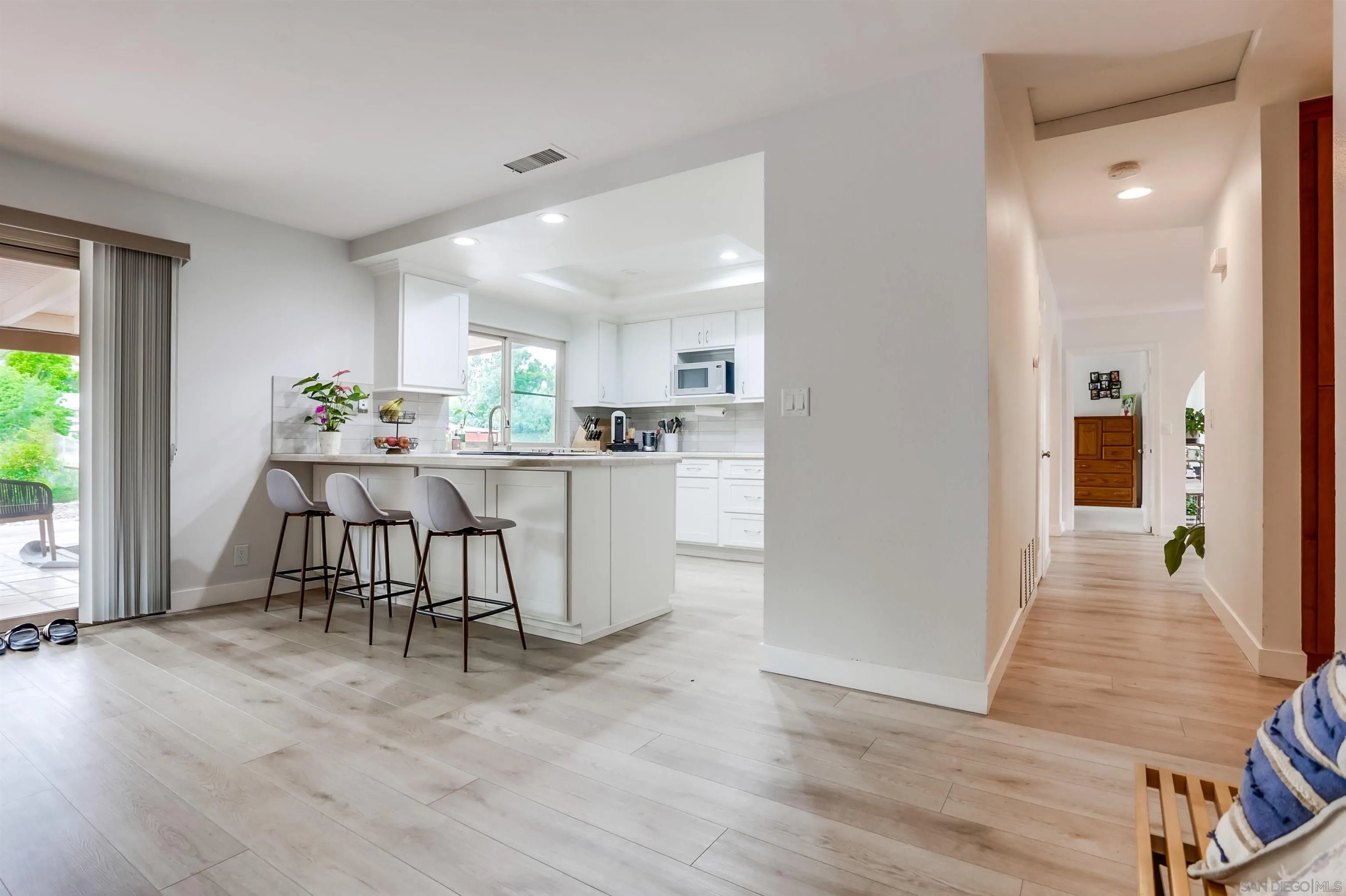 23409 Everett Place Ramona, CA 92065 - Photo 9 of 29 a kitchen with stainless steel appliances a dining table chairs refrigerator and sink
