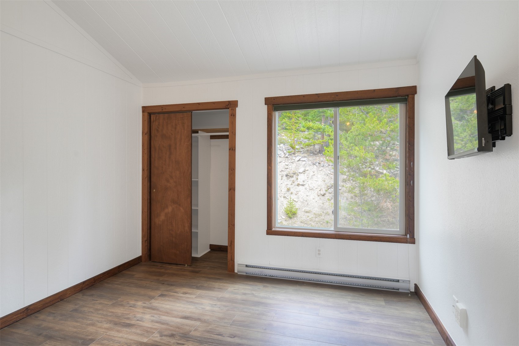 132 Illinois Gulch Road, Unit 3 Breckenridge, CO 80424 - Photo 17 of 32 an empty room with wooden floor and windows