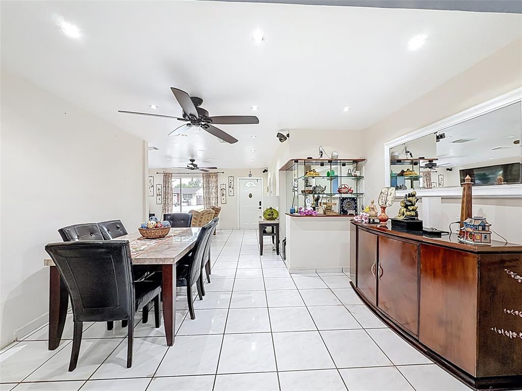 7141 Custer Street Hollywood, FL 33024 - Photo 30 of 84 a kitchen with stainless steel appliances kitchen island granite countertop a table chairs in it and a sink