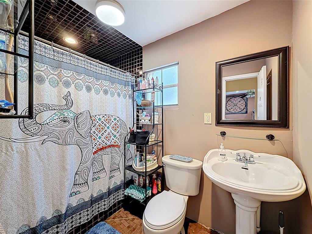 7141 Custer Street Hollywood, FL 33024 - Photo 42 of 84 a bathroom with a toilet sink and mirror