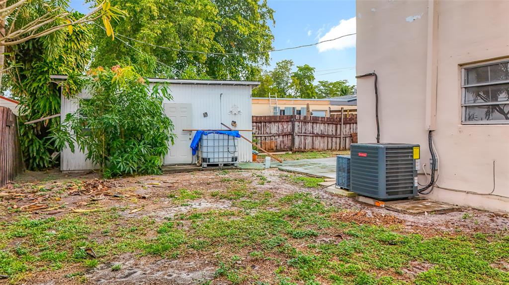 7141 Custer Street Hollywood, FL 33024 - Photo 71 of 84 a backyard of a house with wooden fence and trees