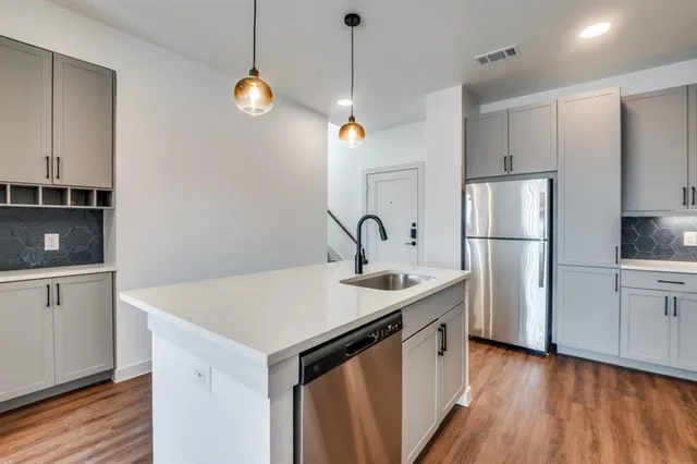 a kitchen with a refrigerator a sink and dishwasher