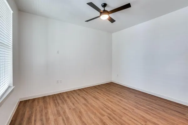 a kitchen with a refrigerator a sink and wooden floor