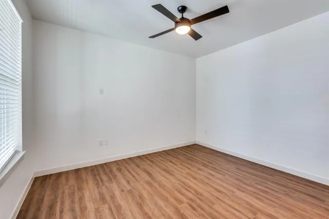 a kitchen with a refrigerator a sink and wooden floor