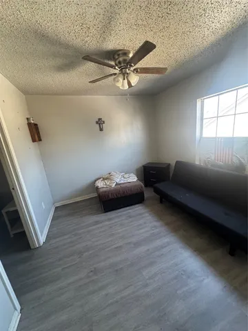 a living room with wooden floor and furniture