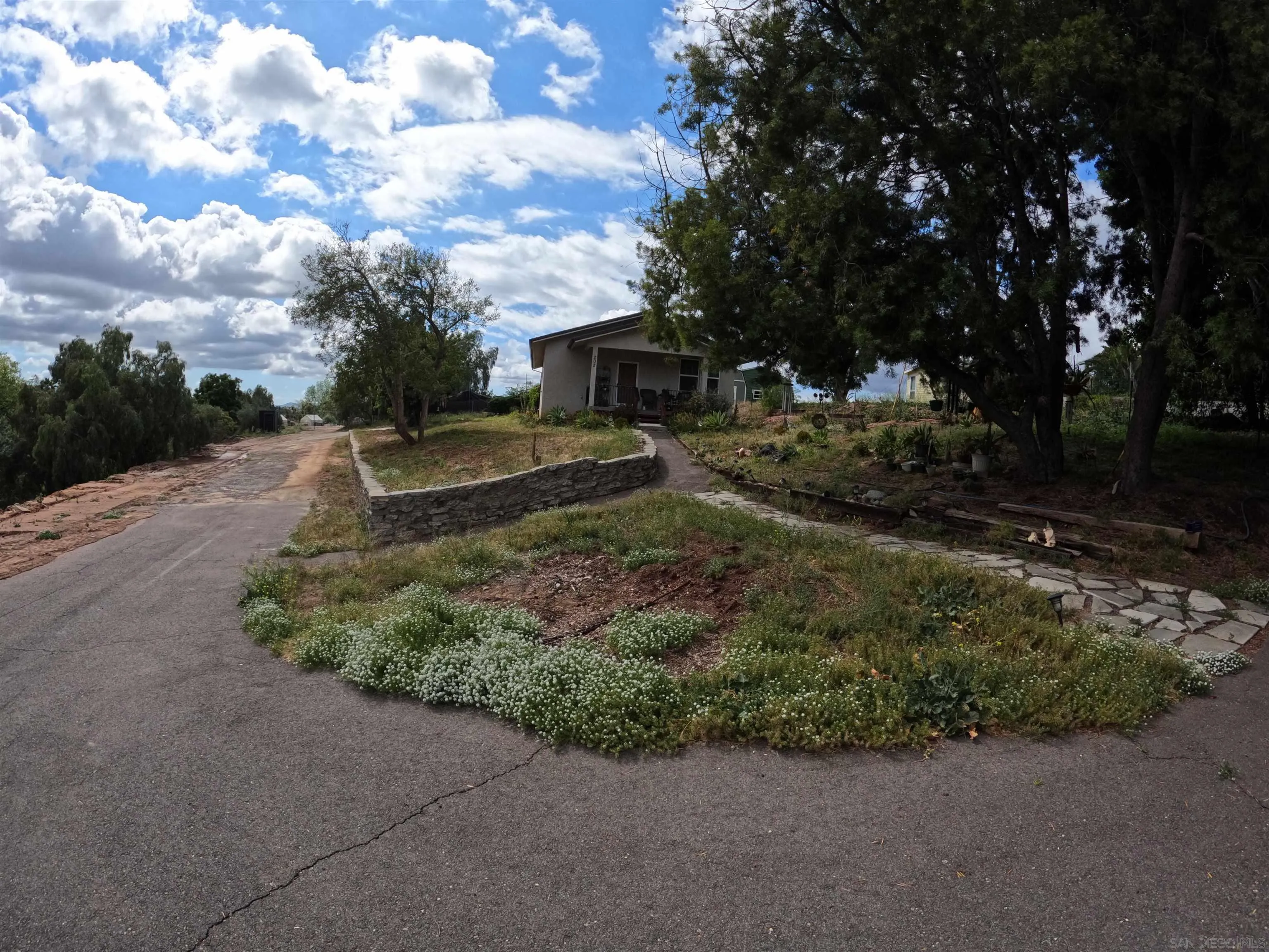 202 North Stage Coach Lane Fallbrook, CA 92028 - Photo 1 of 26 a view of a house with a big yard and large trees