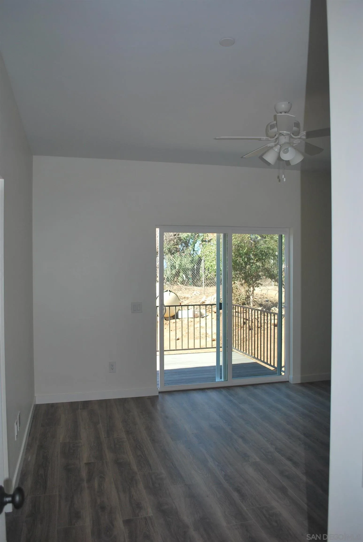 202 North Stage Coach Lane Fallbrook, CA 92028 - Photo 11 of 26 an empty room with wooden floor fan and windows