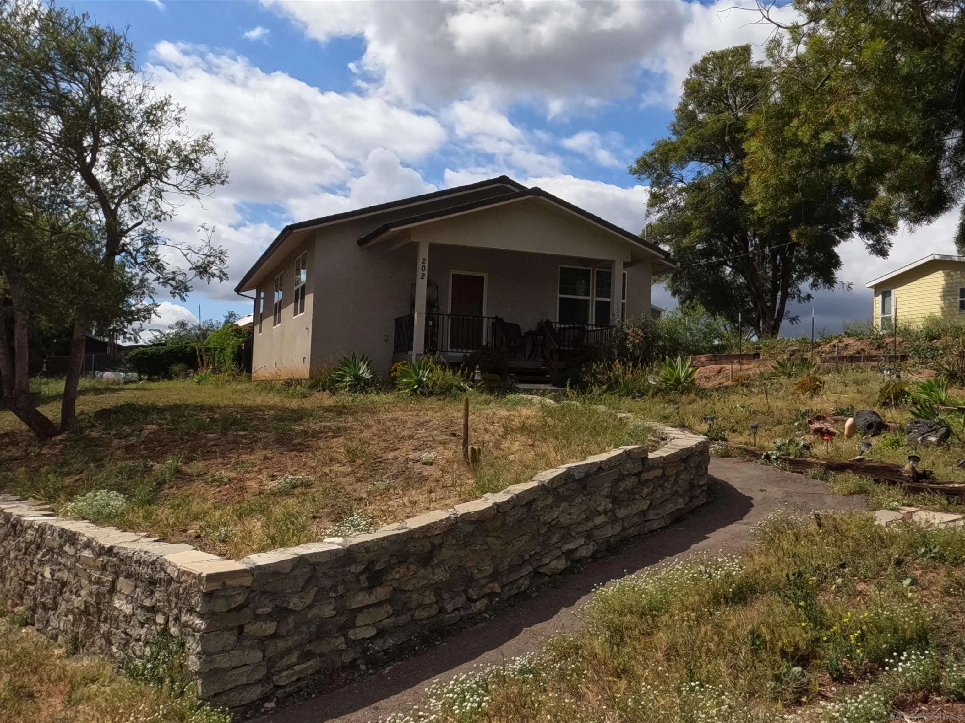 202 North Stage Coach Lane Fallbrook, CA 92028 - Photo 2 of 26 a view of a house with a yard