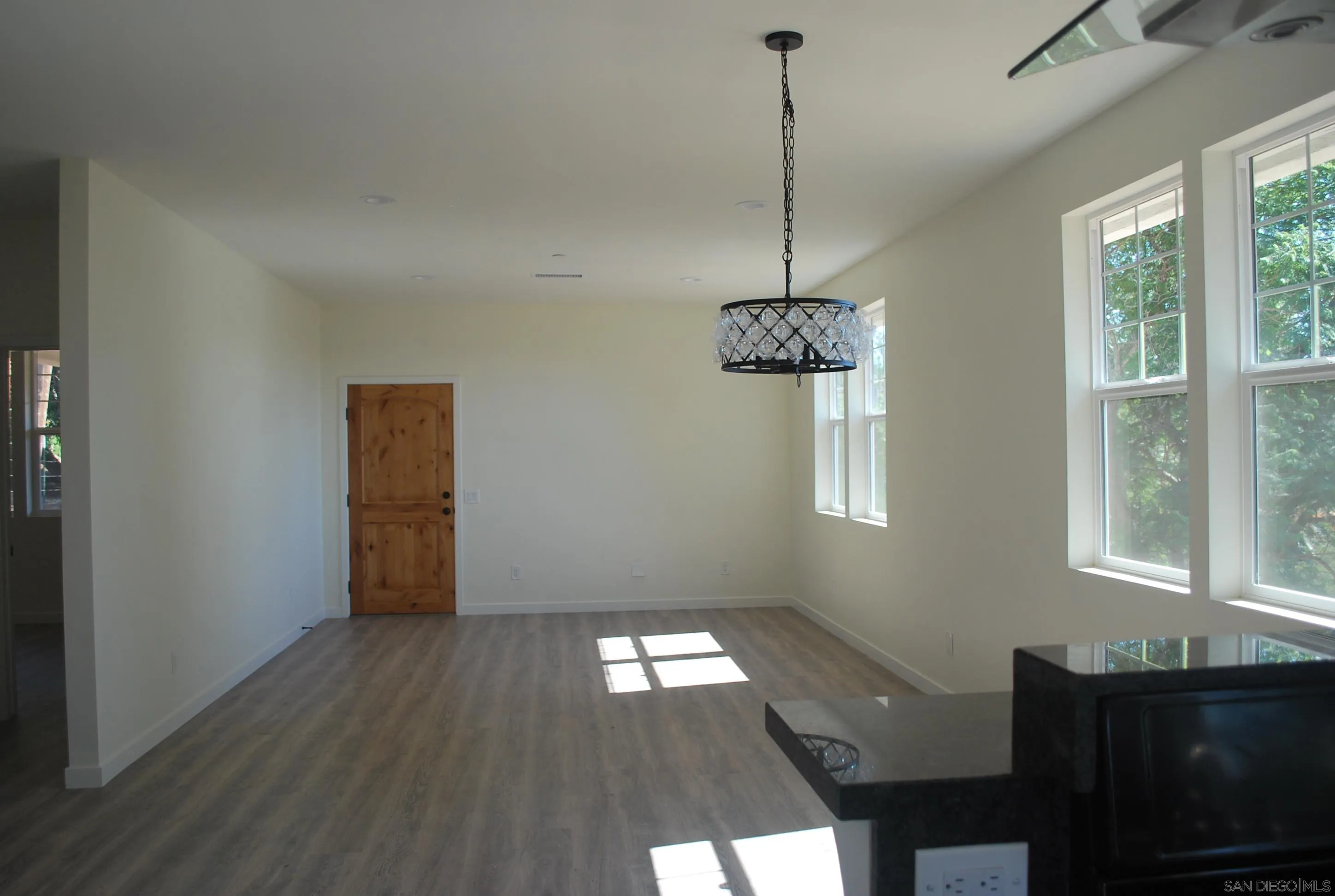 202 North Stage Coach Lane Fallbrook, CA 92028 - Photo 5 of 26 a view of empty room with wooden floor and windows