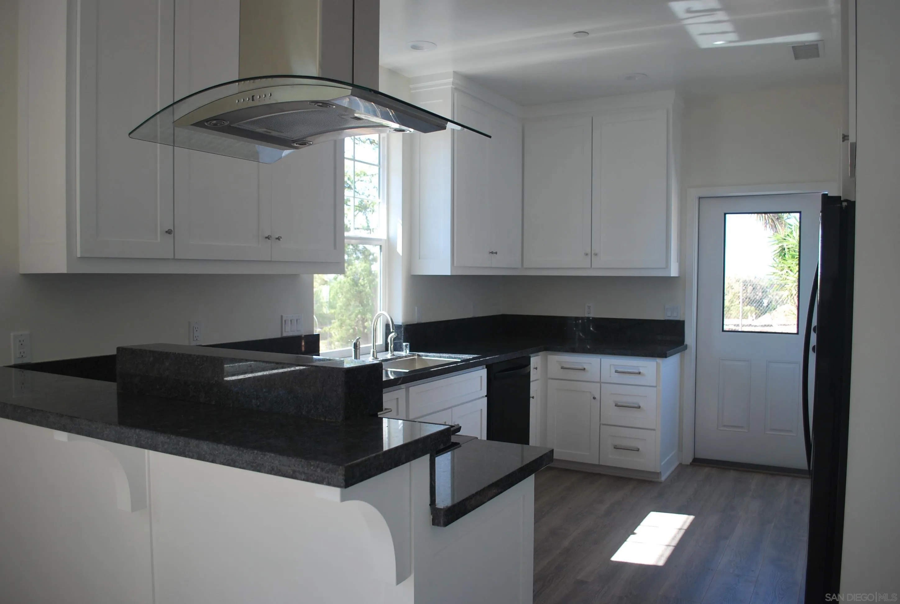 202 North Stage Coach Lane Fallbrook, CA 92028 - Photo 6 of 26 a kitchen with granite countertop white cabinets and a stove