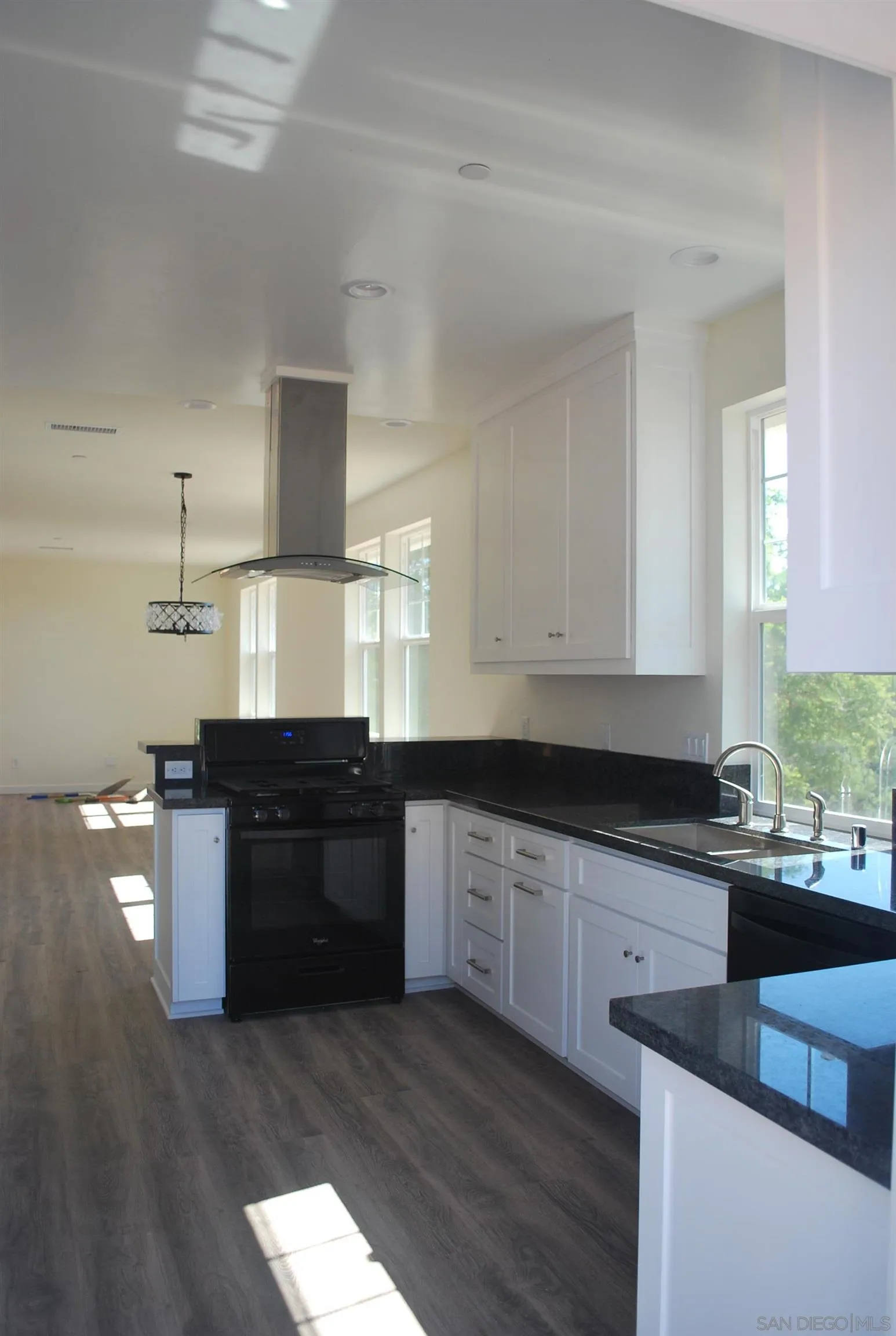 202 North Stage Coach Lane Fallbrook, CA 92028 - Photo 8 of 26 a kitchen with granite countertop a stove and cabinets