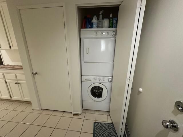 a patio with table and chairs and potted plants