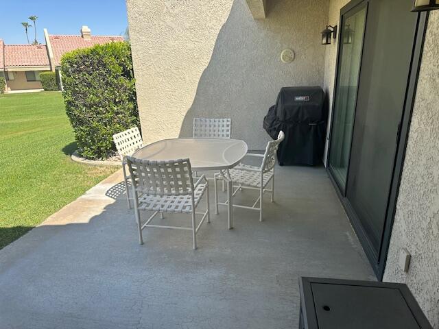 41694 Preston Trail Palm Desert, CA 92211 - Photo 17 of 20 a patio with table and chairs and potted plants