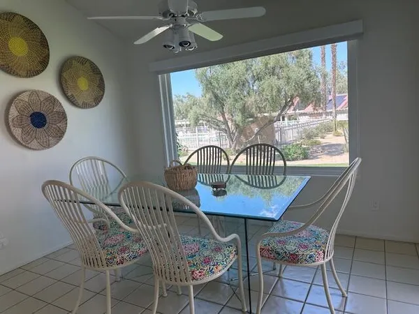 a dining room with furniture and window