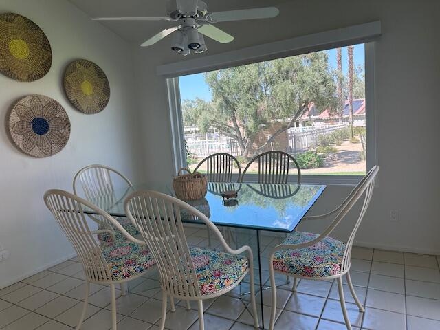 41694 Preston Trail Palm Desert, CA 92211 - Photo 7 of 20 a view of a dining room with furniture chandelier and a large window