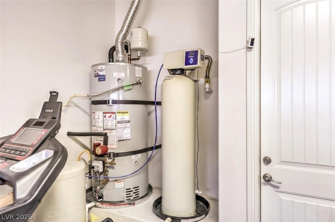 7119 Arabian Ridge Street Las Vegas, NV 89131 - Photo 61 of 73 Essential utilities including a water heater and softener are neatly installed, ensuring seamless operation.