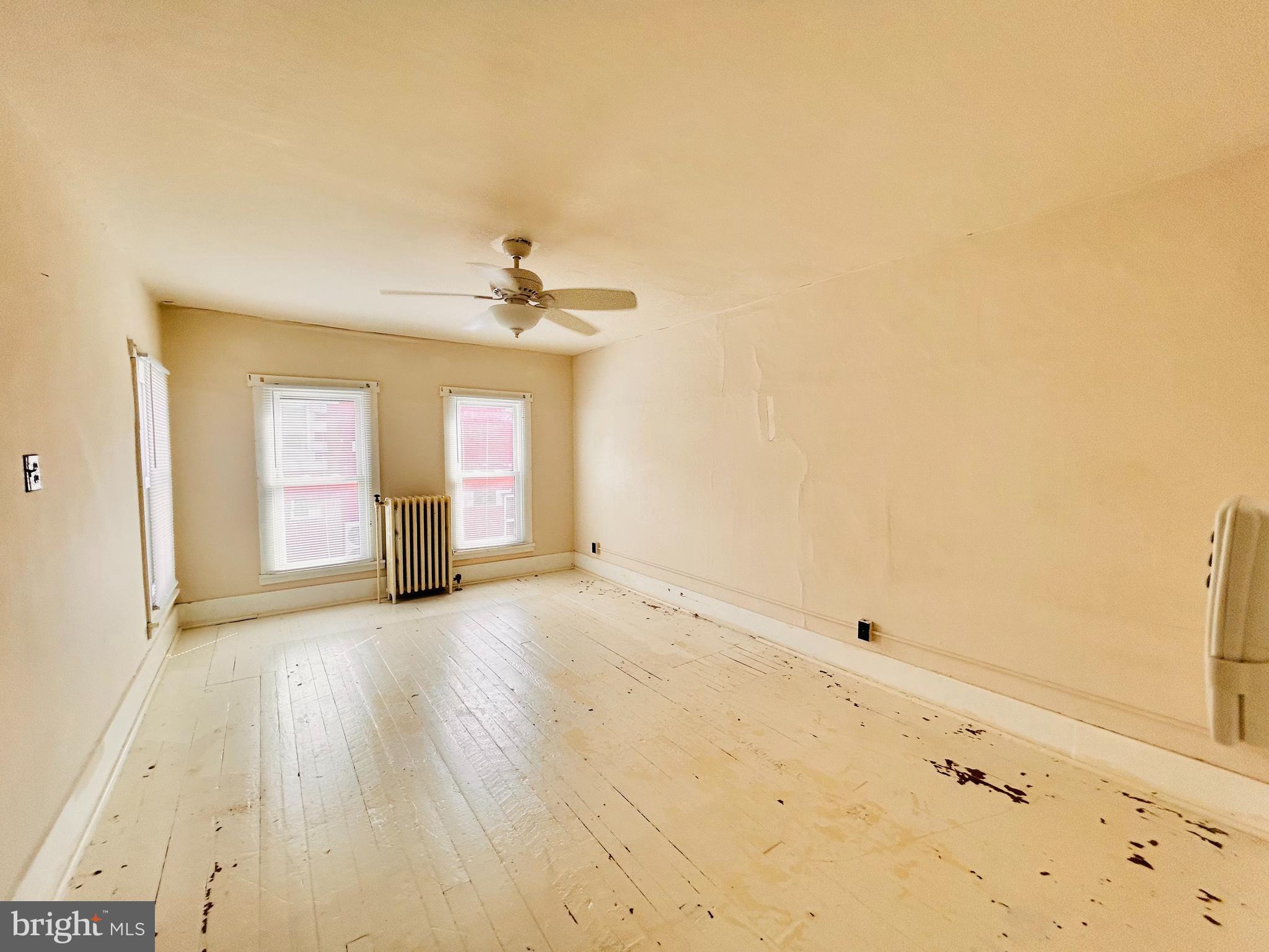 113 West Main Street Millheim, PA 16854 - Photo 14 of 30 an empty room with wooden floor and windows