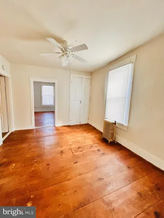 an empty room with windows and closet