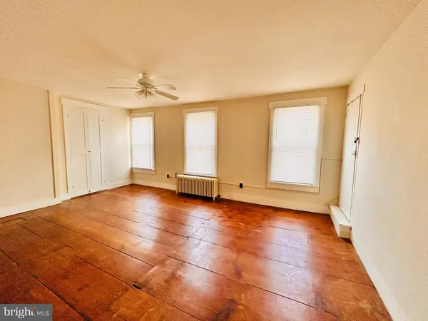 a view of a livingroom with an empty space and a window